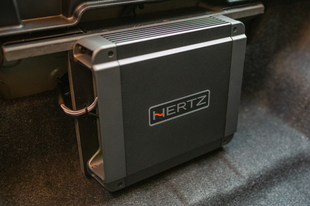 Hertz Amplifier in BMW i5 Trunk Storage Compartment
